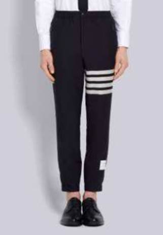 A person wearing black pants with white stripes

Description automatically generated